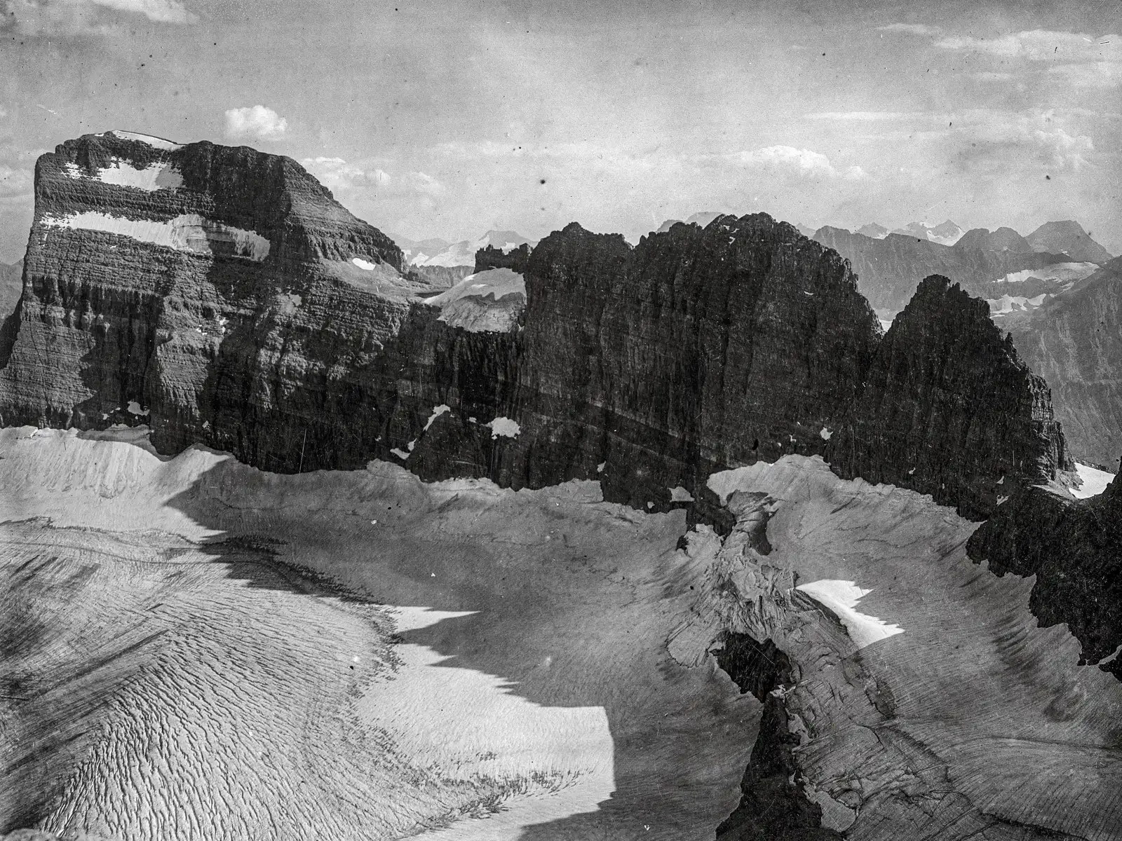 a black and white landscape of a big glacier and mountains