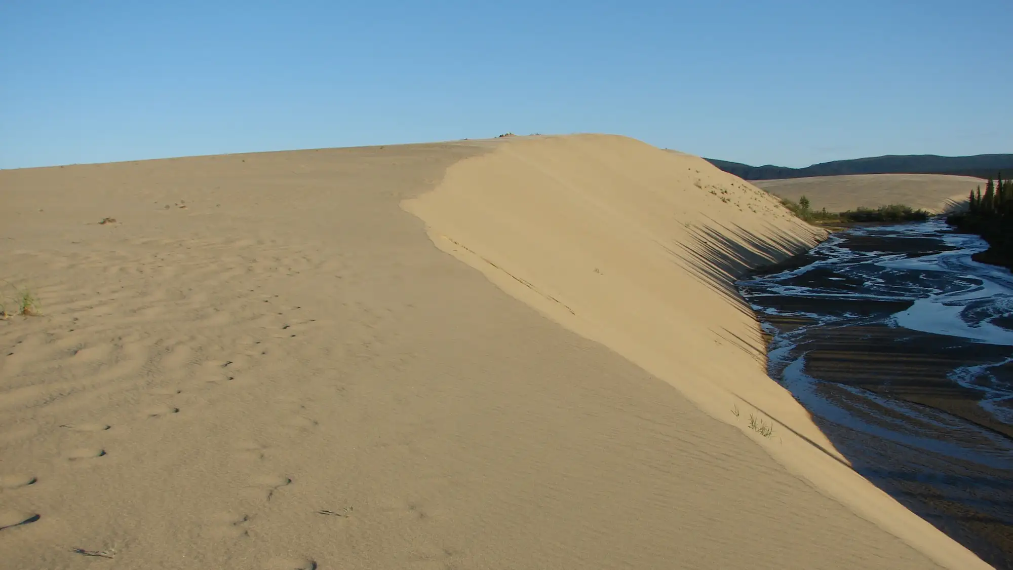 sun setting on sand dunes
