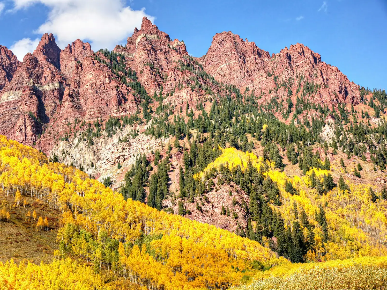 Rugged Colorado peaks above golden autumn aspens