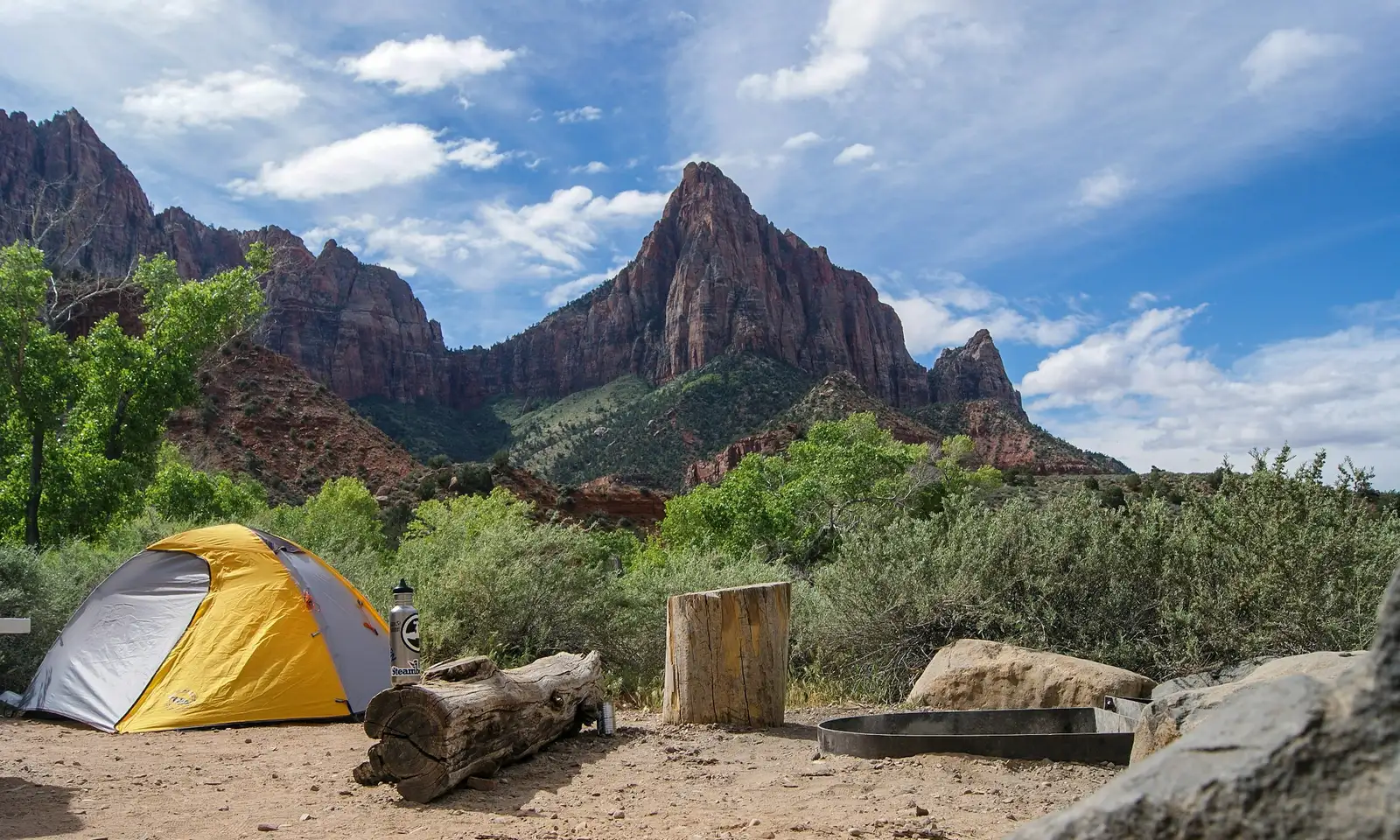 Tent beside a mountain lake at dusk